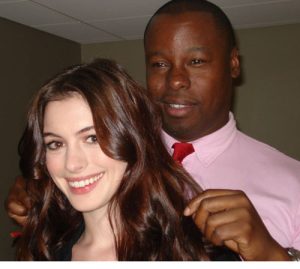 Ted Gibson stands behind a smiling Anne Hathaway