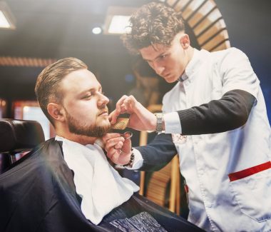 Men's hairstyling and haircutting in a barber shop or hair salon. Men's Hairdressers barbers.